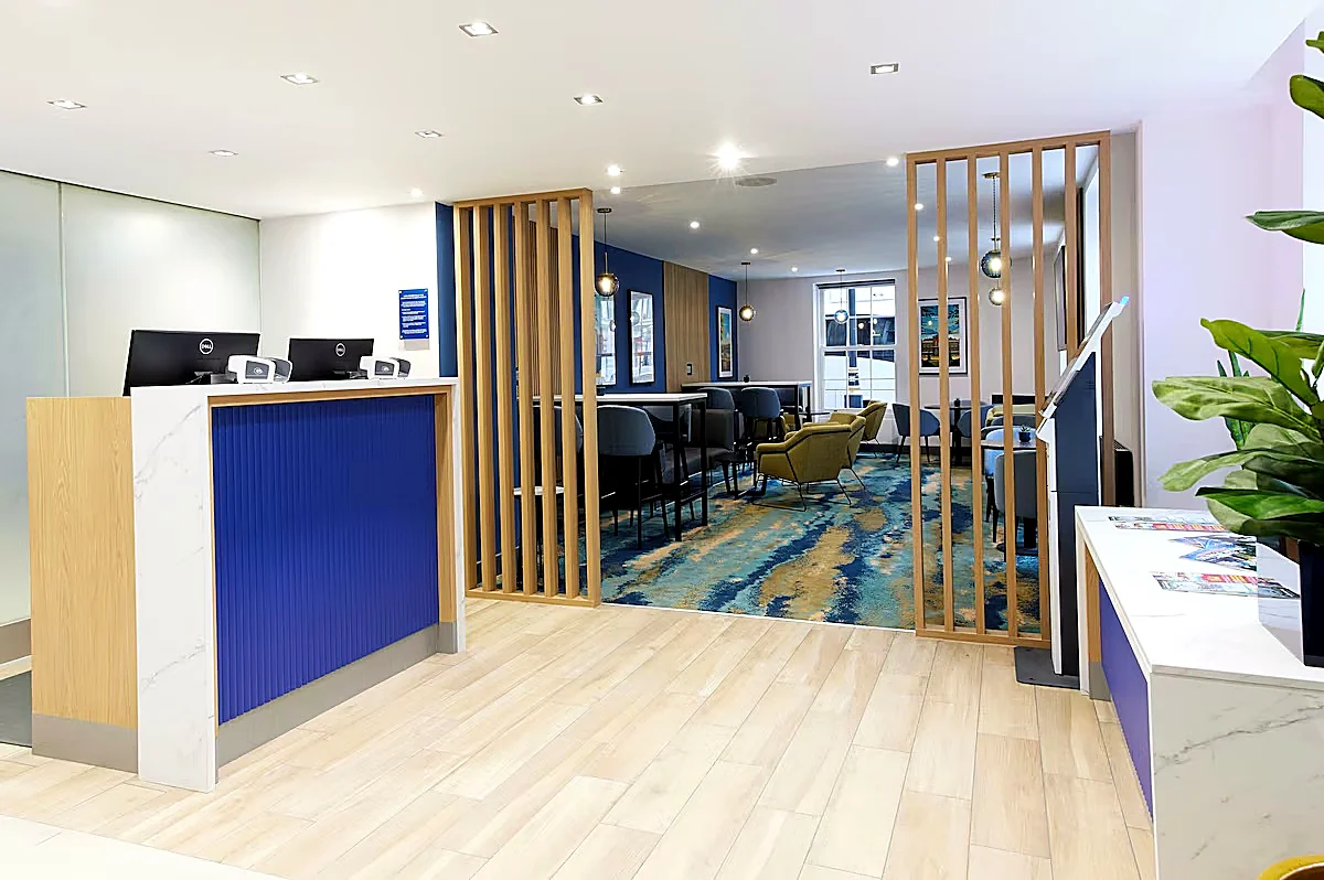 Hospitality reception area with bespoke desk and timber screening