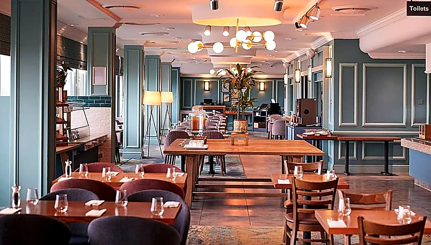 Restaurant dining area with decorative wall panelling and warm lighting