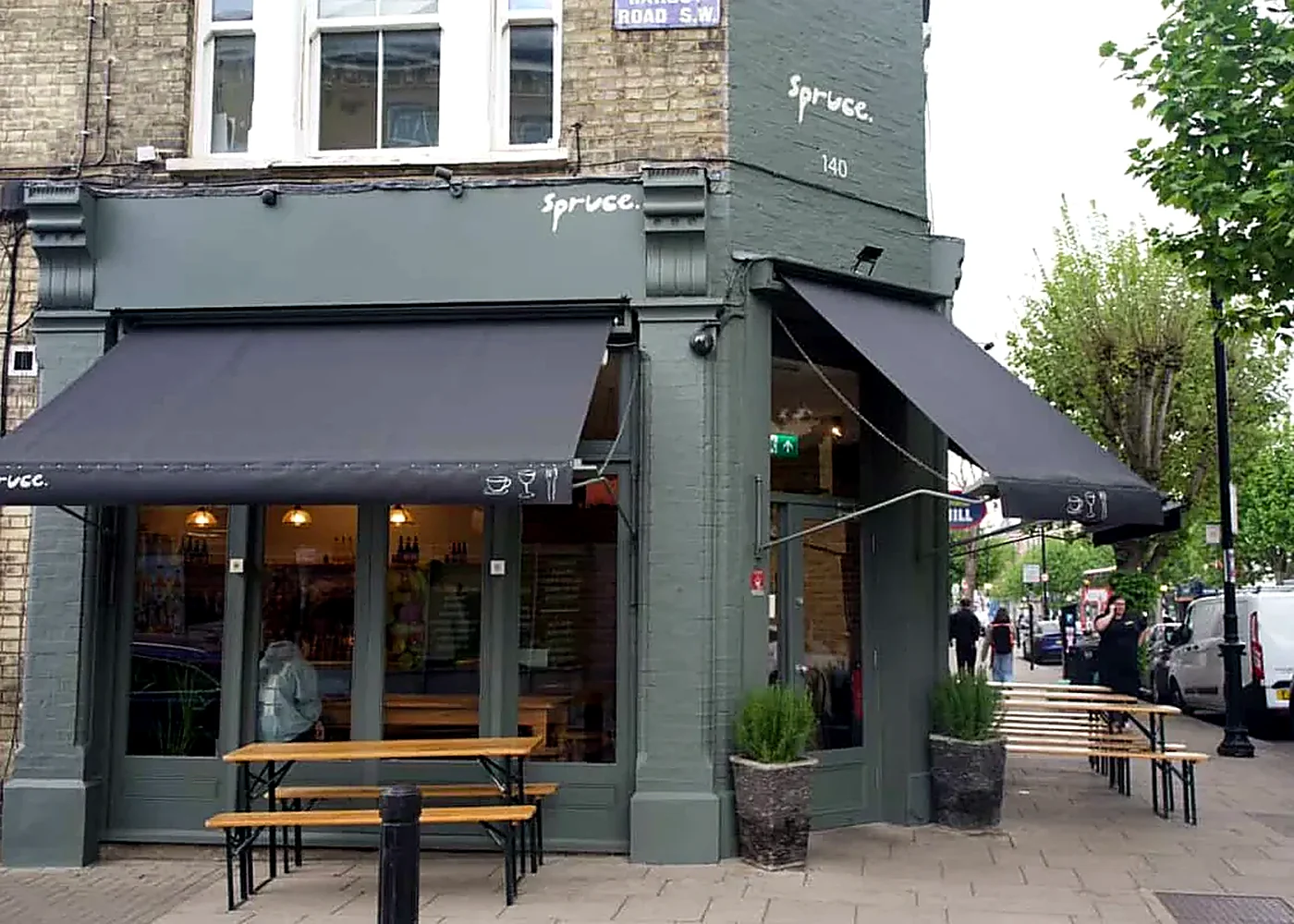 Exterior view of neighbourhood café with bespoke frontage and awnings