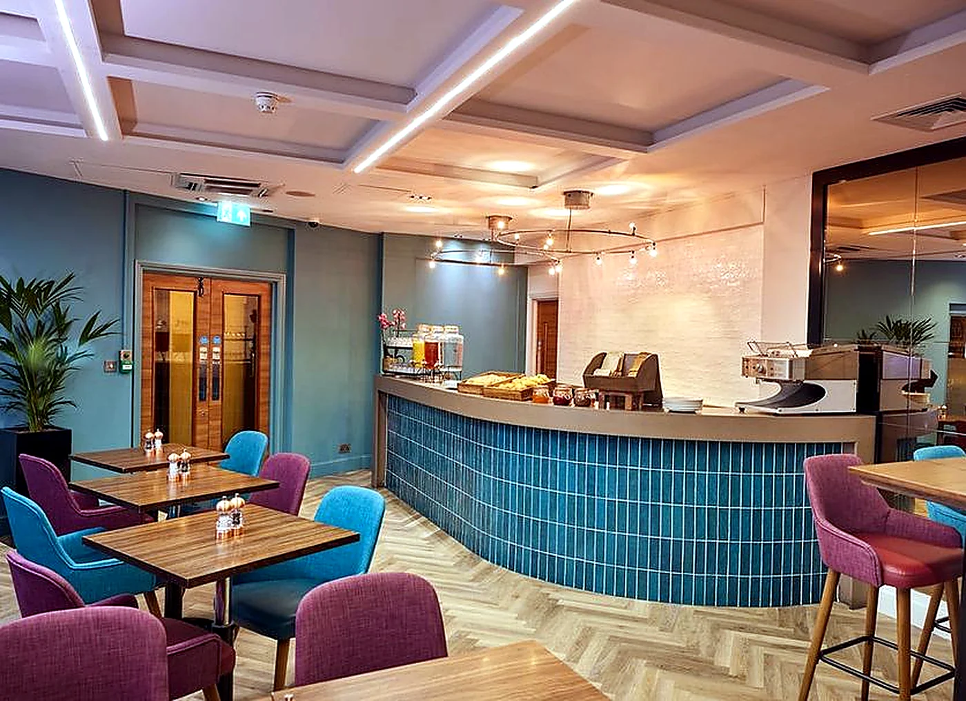 Hospitality breakfast bar with curved counter and seating area