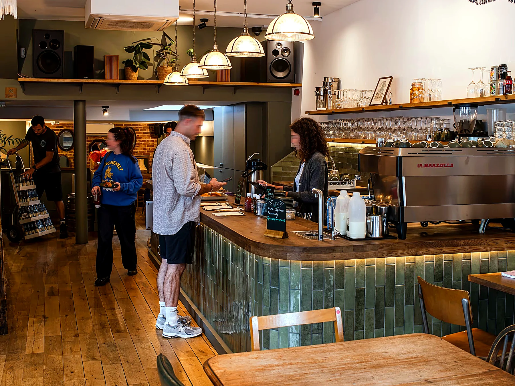 Coffee bar interior with customers and bespoke tiled counter