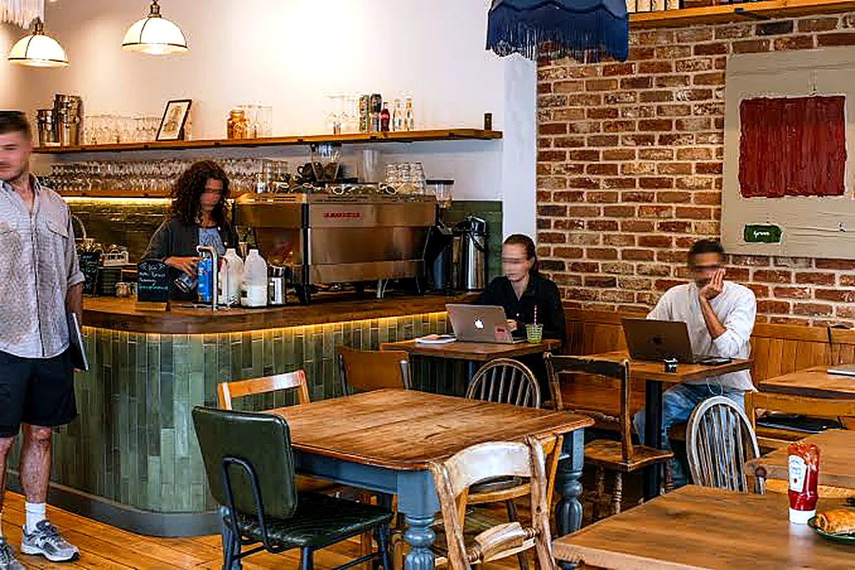 Neighbourhood café interior with customers and bespoke tiled coffee counter
