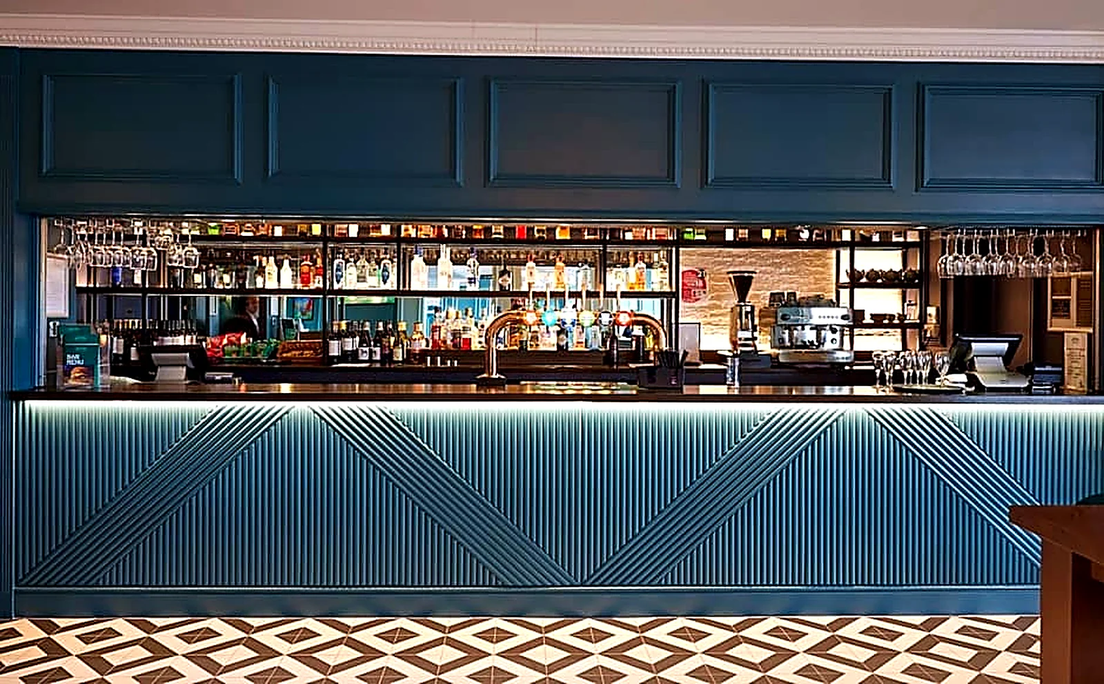 Statement back bar with bespoke fluted frontage and integrated shelving