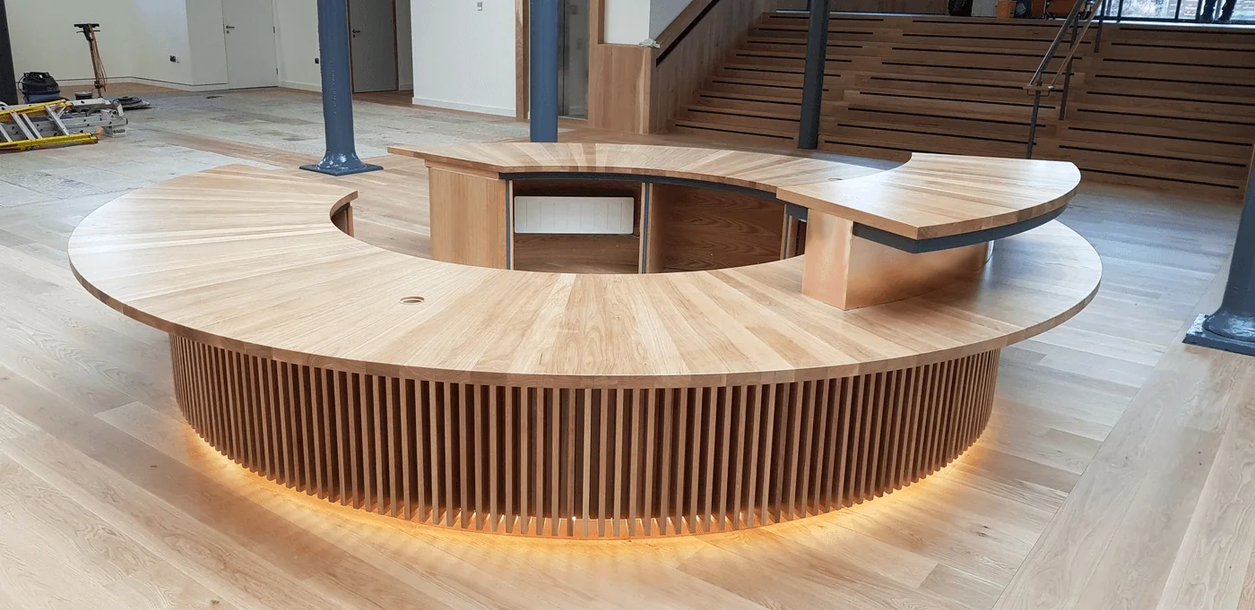 Bespoke timber reception desk within a contemporary commercial interior