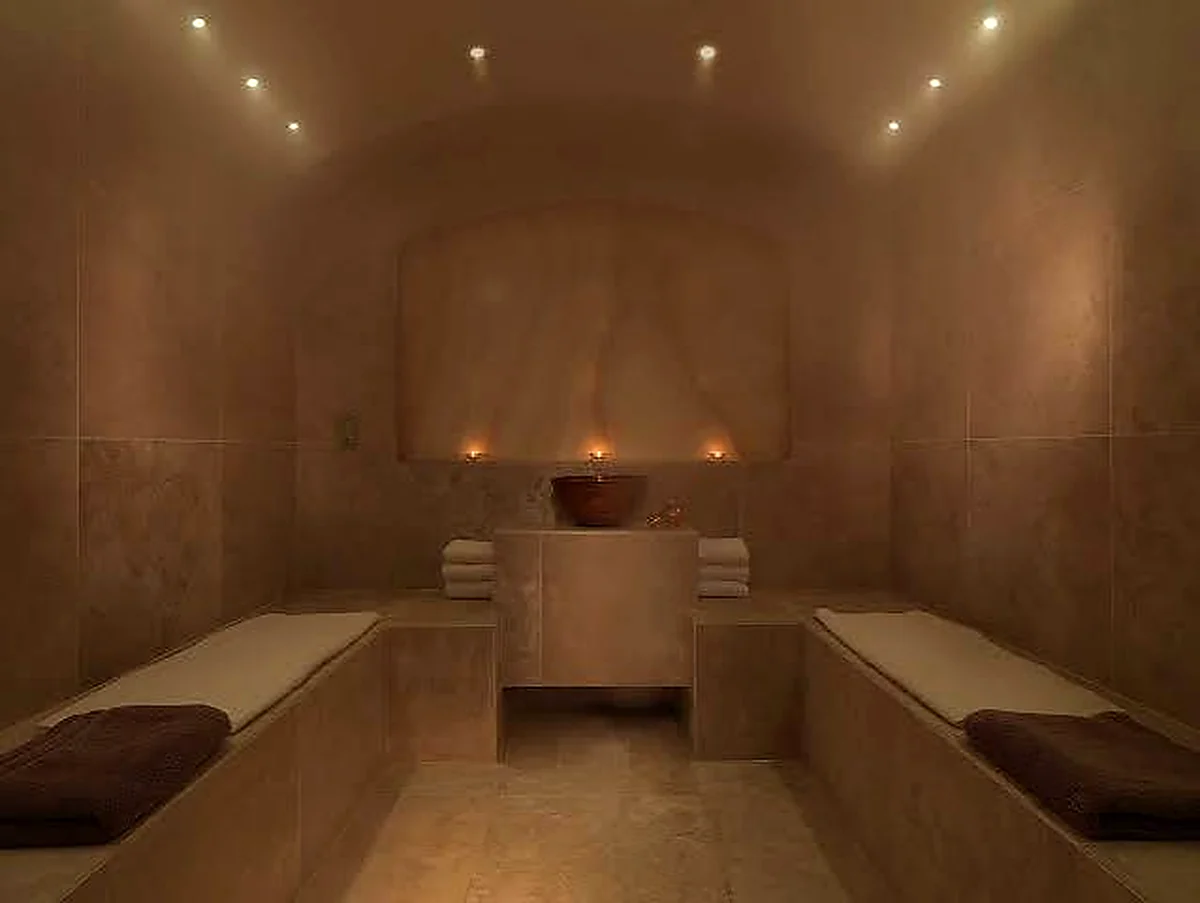 Dolphin Square Spa steam room with tiled benches and central wash feature