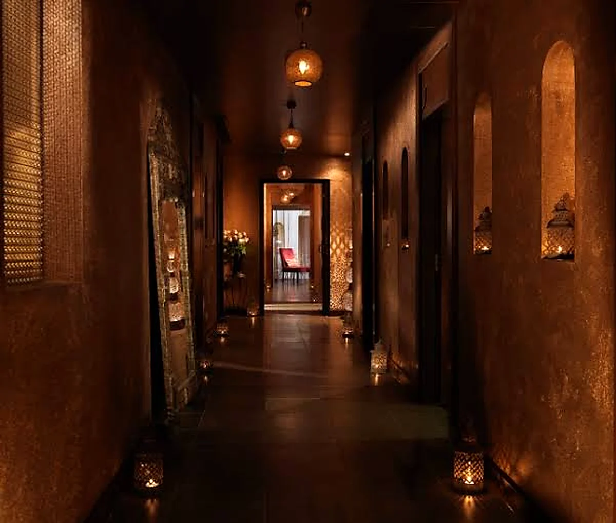 Warmly lit spa corridor with decorative niches and lanterns