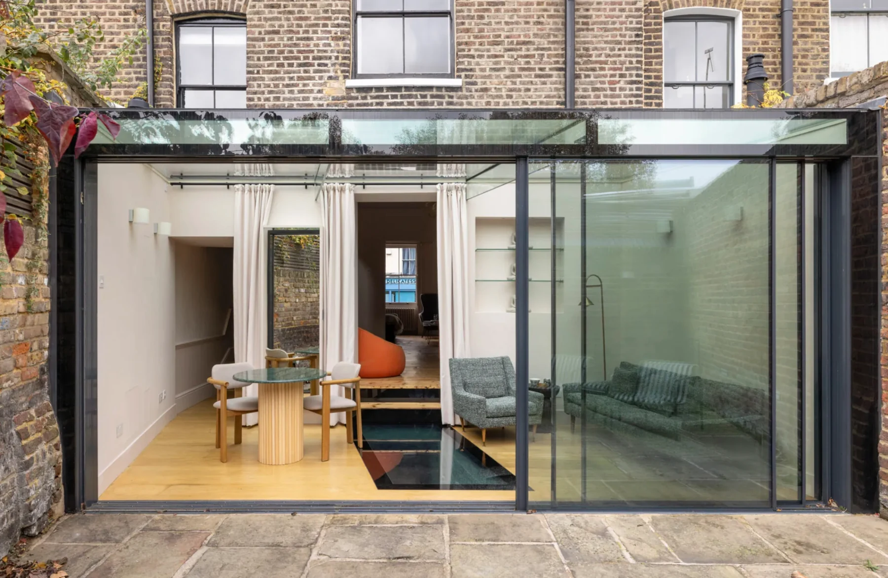 Glazed rear extension connecting a period property to the garden