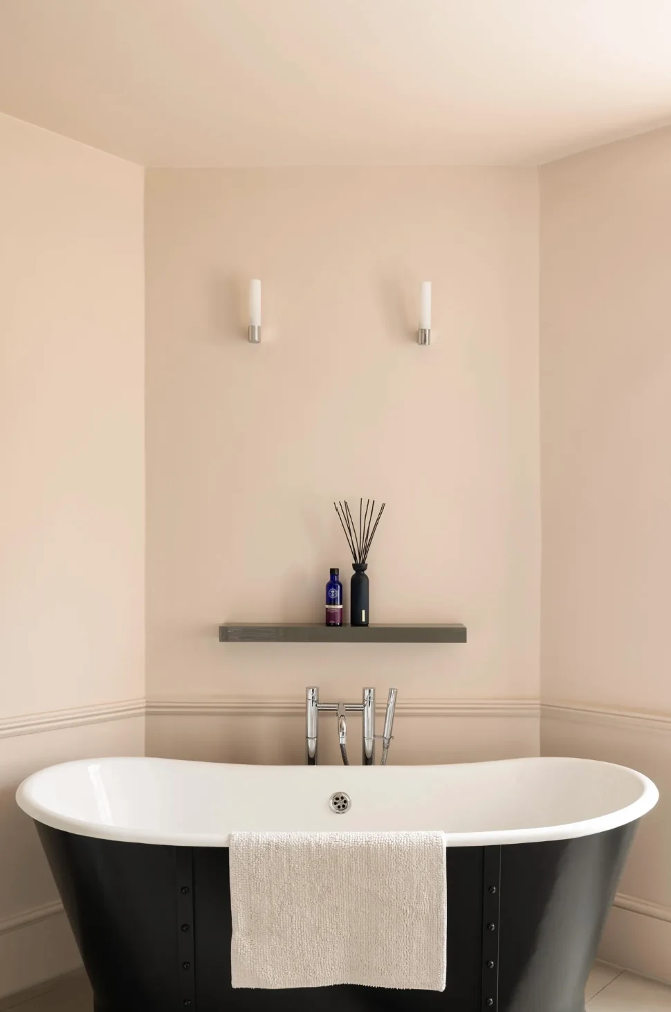 Freestanding roll-top bath in a softly finished residential bathroom