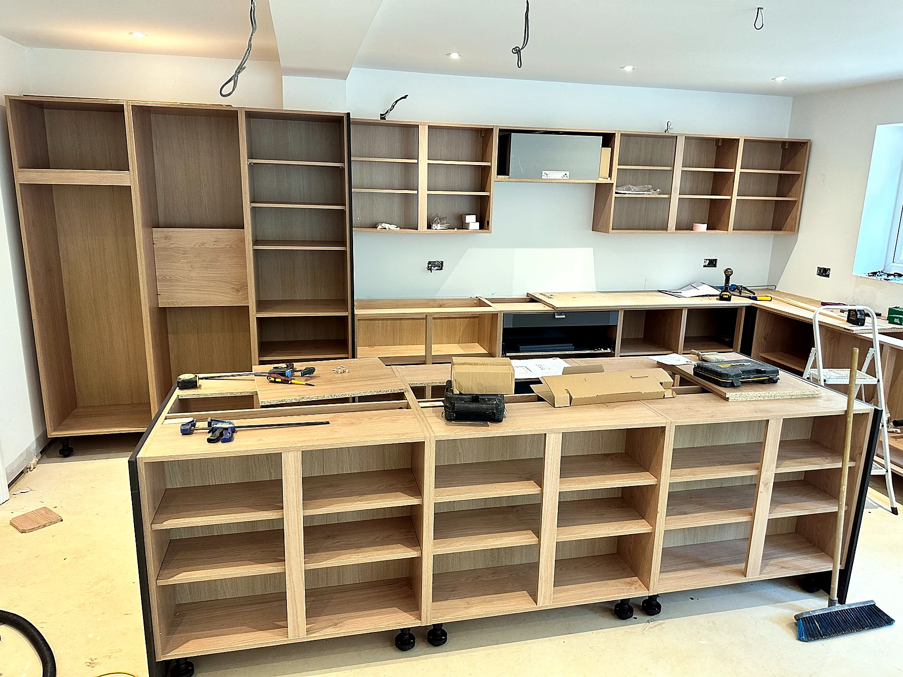 Bespoke kitchen joinery being installed within a residential extension